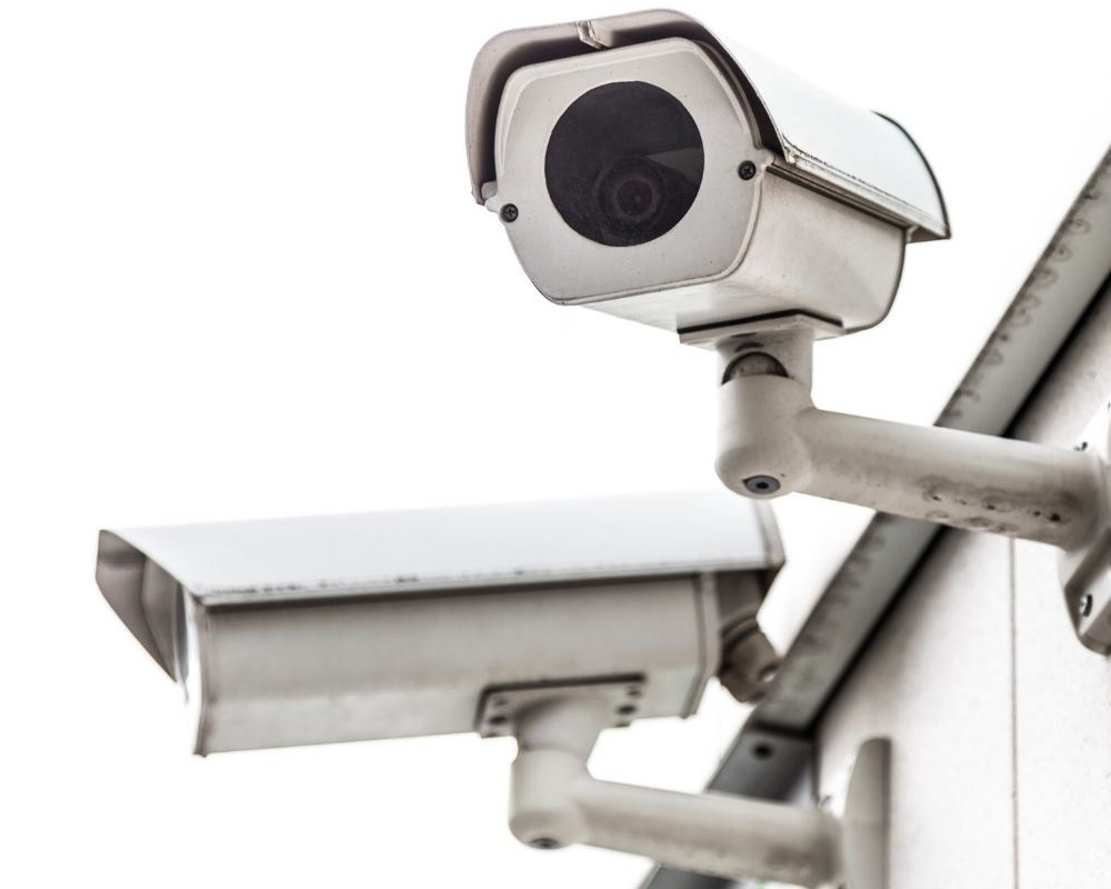 Alarm system camera attached to a building